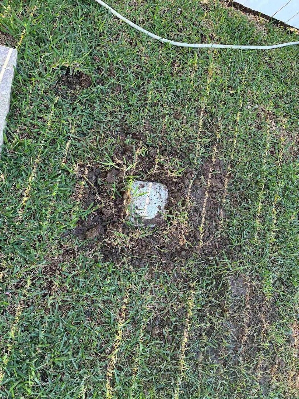 The sewer inspection opening (IO) cut down and set to ground level